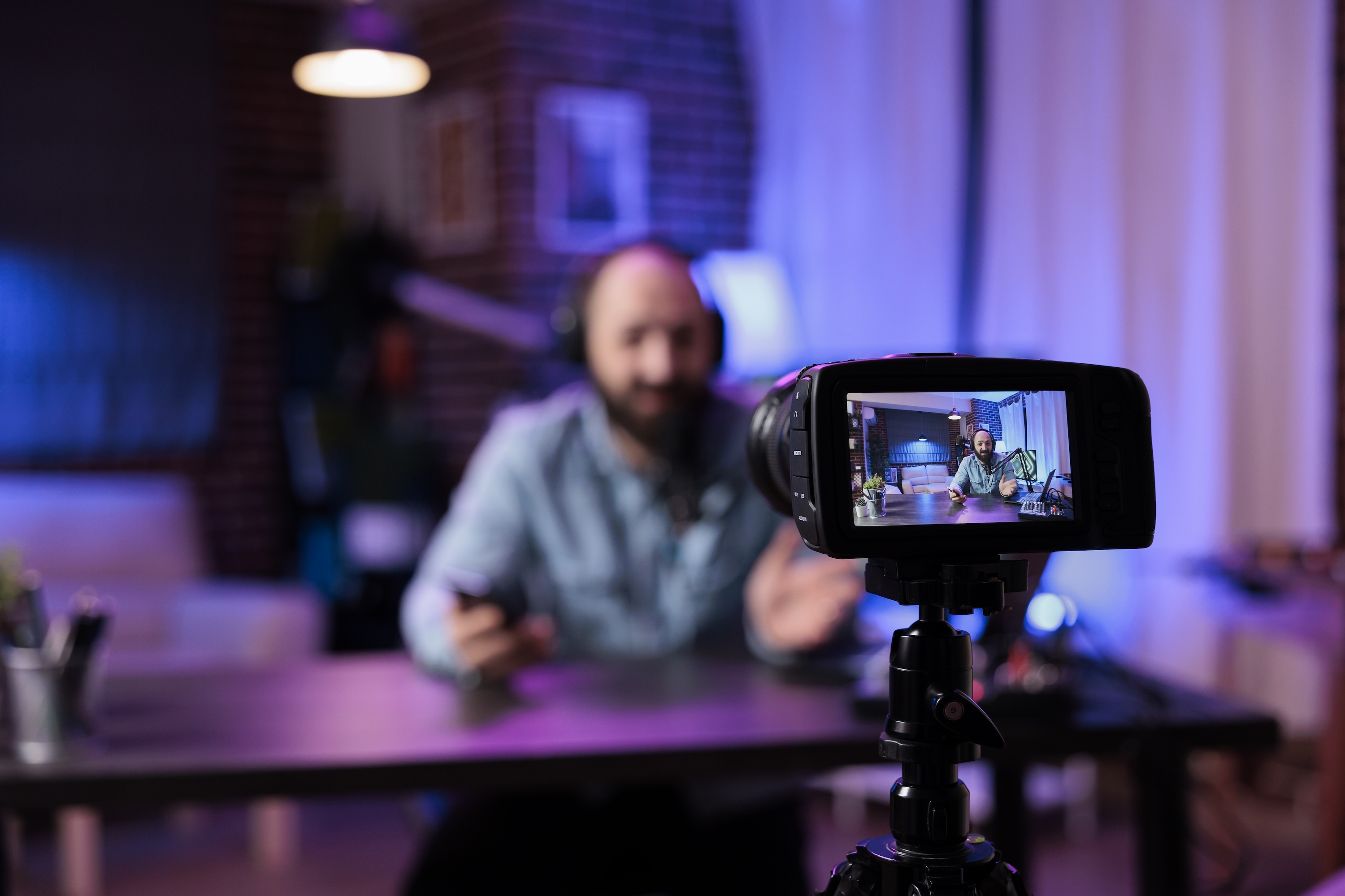 Man using camera to record video podcast