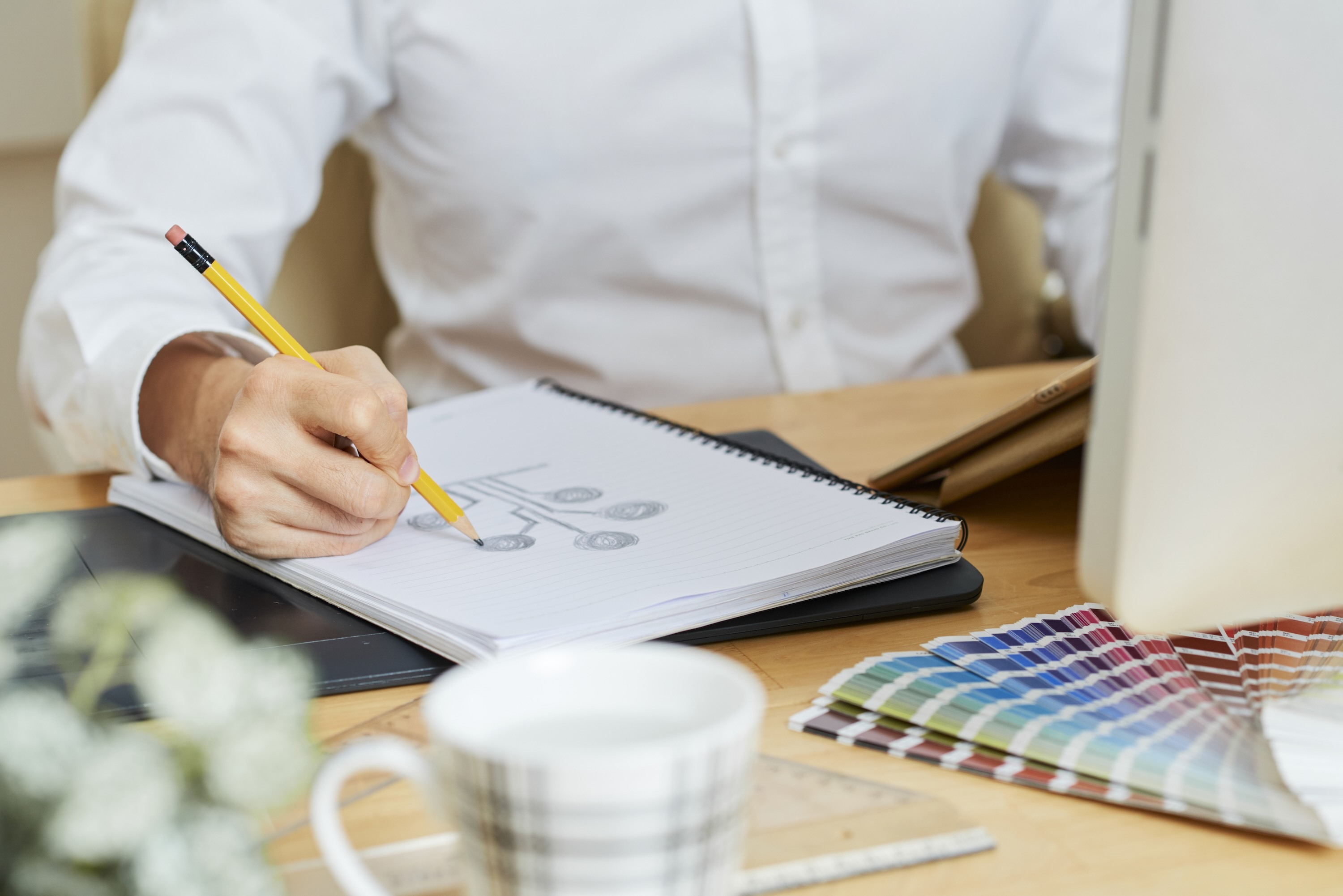 Designer working on logo sketch.