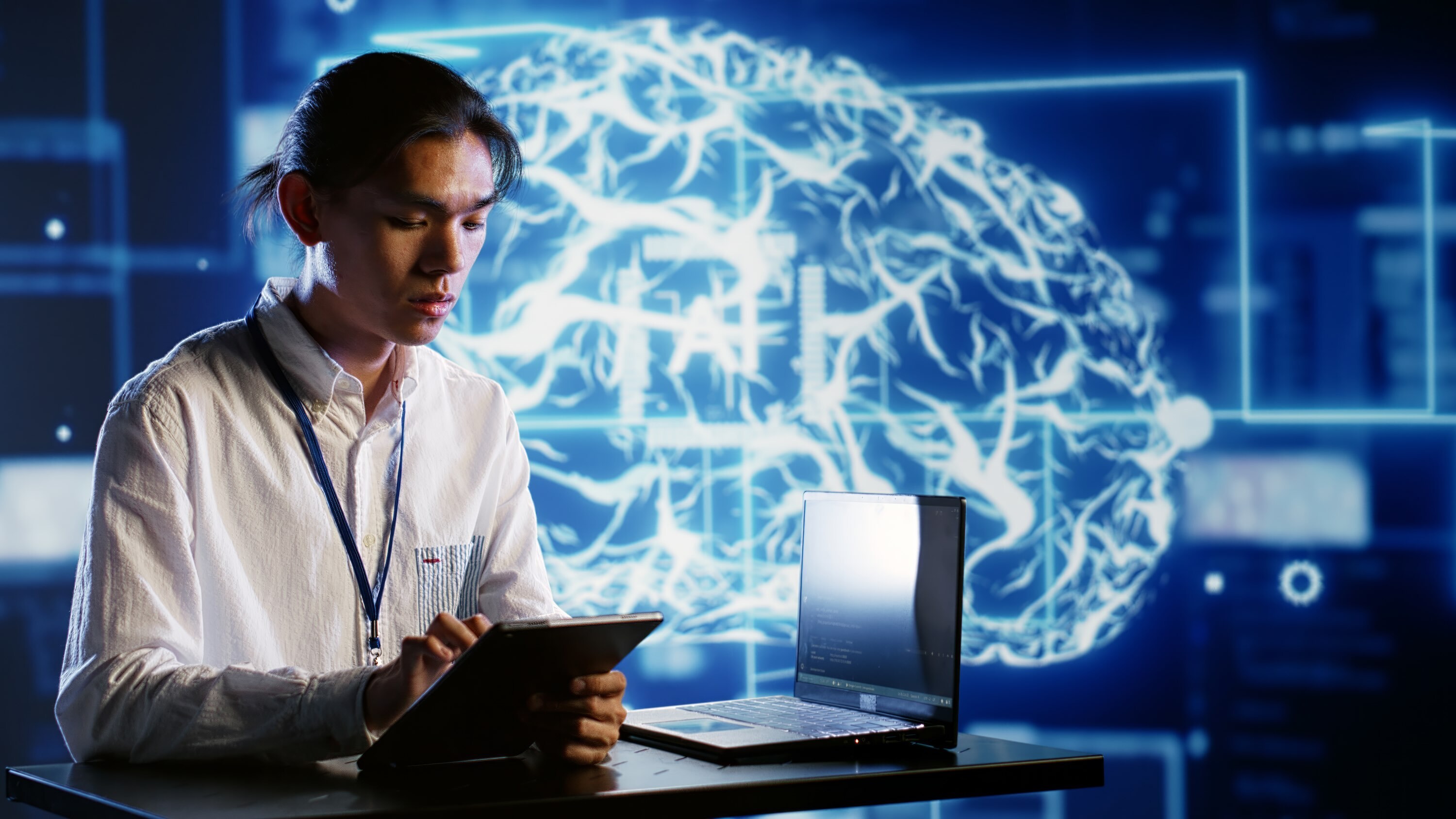 Employee Develops Ai Neural Network Blue Brain outline in dark background
