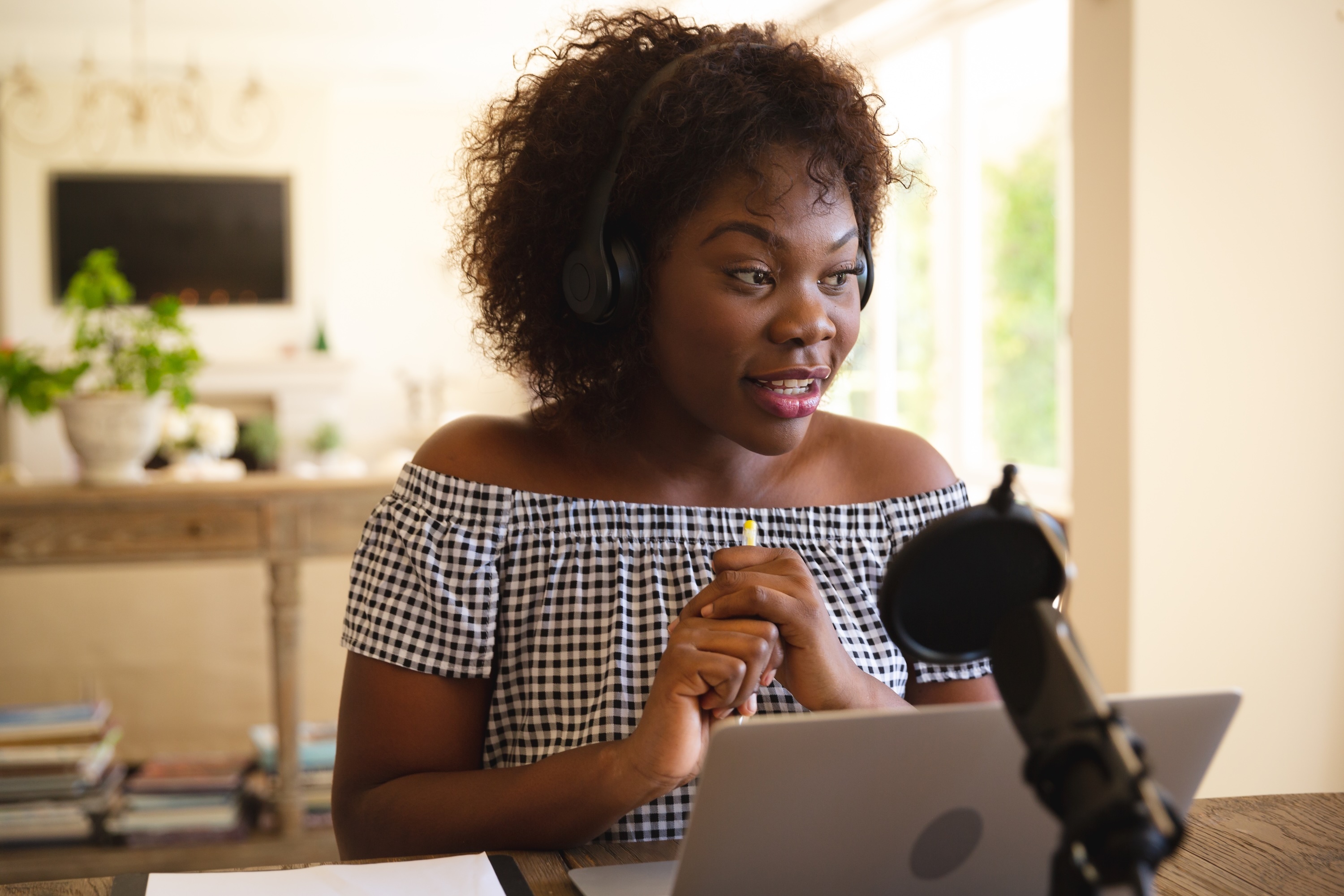 Woman recording podcast at home